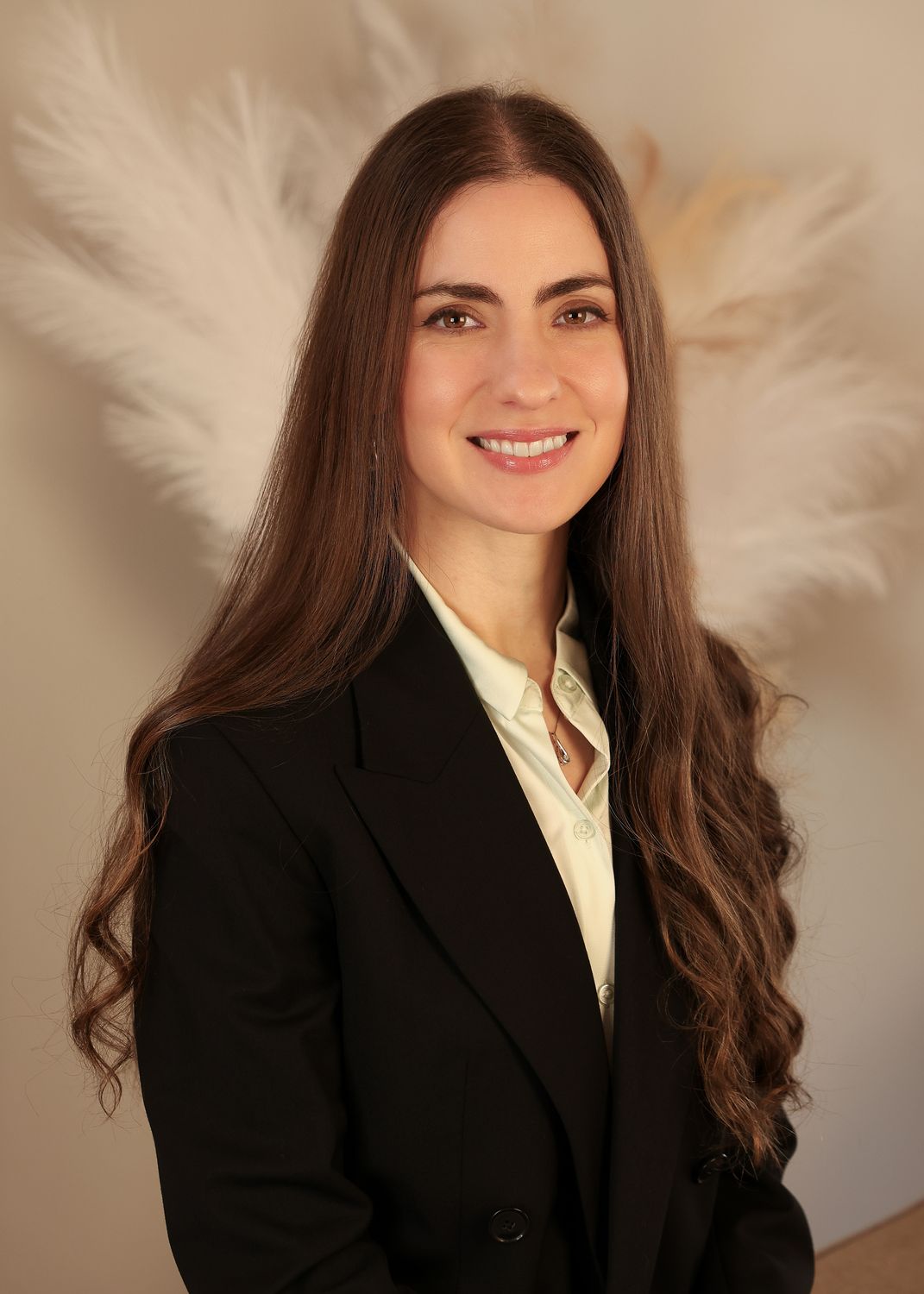 Professional woman smiling in business attire.